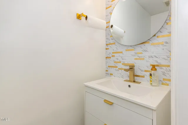a bathroom with a sink and mirror