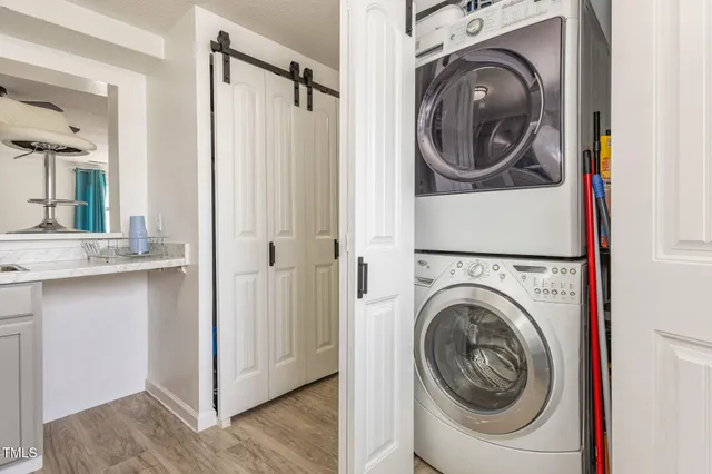 a view of a hallway with washer and dryer