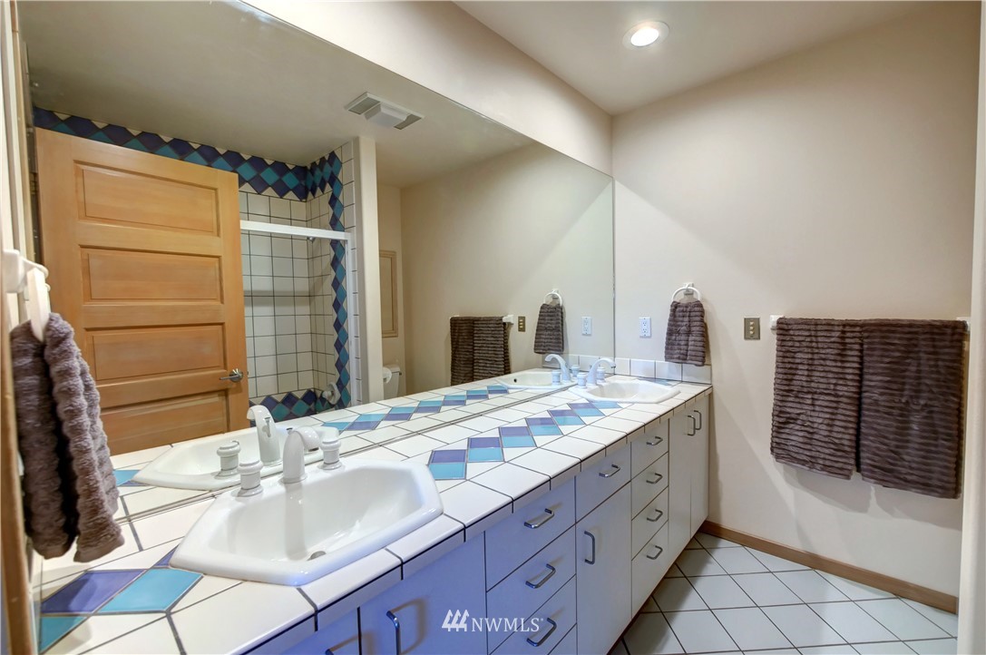 25 Black Road Omak, WA 98841 - Photo 27 of 38 a bathroom with a sink double vanity and a shower