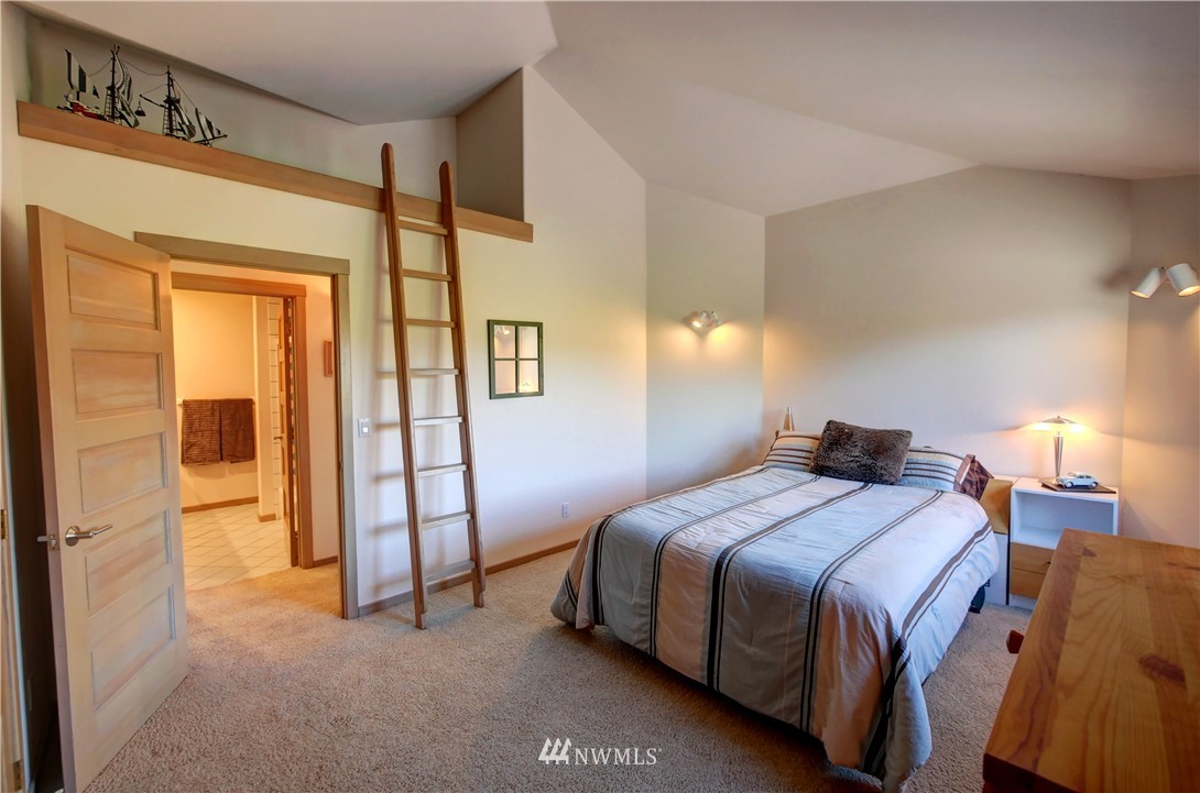 25 Black Road Omak, WA 98841 - Photo 30 of 38 a bedroom with a bed and wooden floor