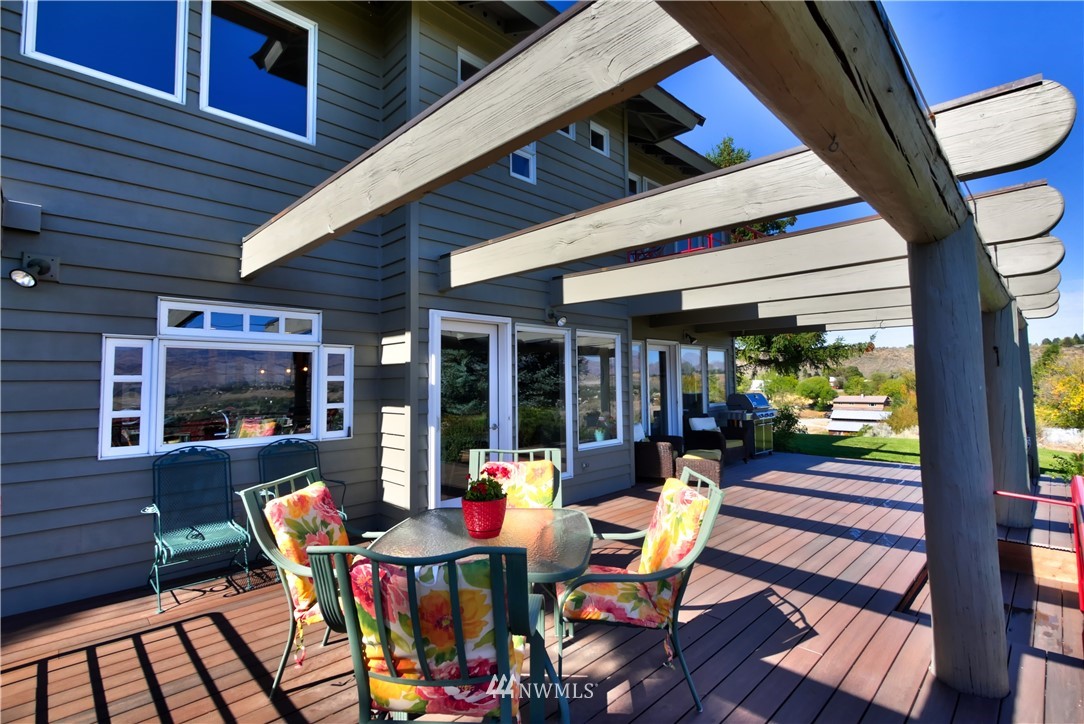 25 Black Road Omak, WA 98841 - Photo 31 of 38 a view of a patio with table and chairs and wooden floor