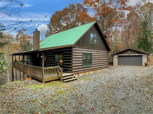 a backyard of a house with wooden fence and deck