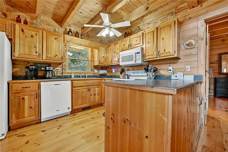 100 Arrow Way Mineral Bluff, GA 30559 - Photo 18 of 53 a kitchen with stainless steel appliances granite countertop a sink a stove cabinets and wooden floor