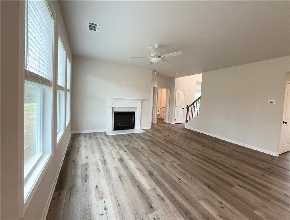 345 Rodeo Drive Auburn, GA 30011 - Photo 6 of 22 a view of empty room with wooden floor and fan