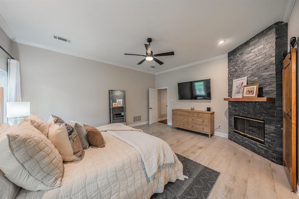 115 Pheasant Run Road Argyle, TX 76226 - Photo 15 of 40 a bedroom with a bed and a flat screen tv