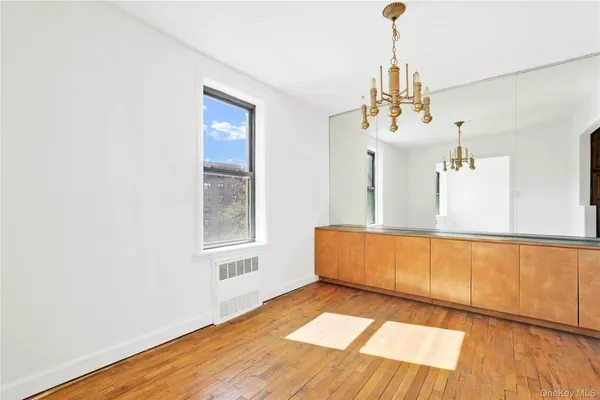 a view of a room with wooden floor and cabinet