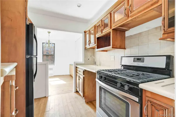 a kitchen with stainless steel appliances granite countertop a stove and a refrigerator