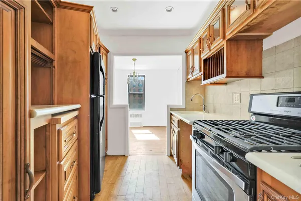 a kitchen with stainless steel appliances granite countertop a stove and a refrigerator