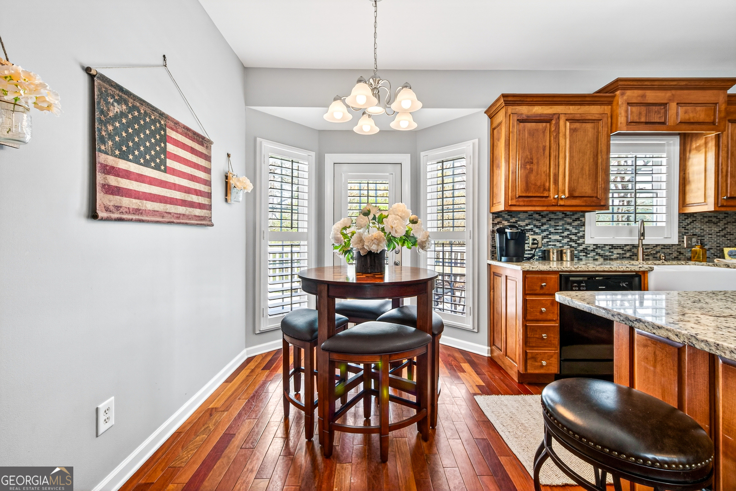 1071 Louden Ridge Road Alto, GA 30510 - Photo 13 of 81 a dining room with wooden floor a chandelier a wooden table and chairs