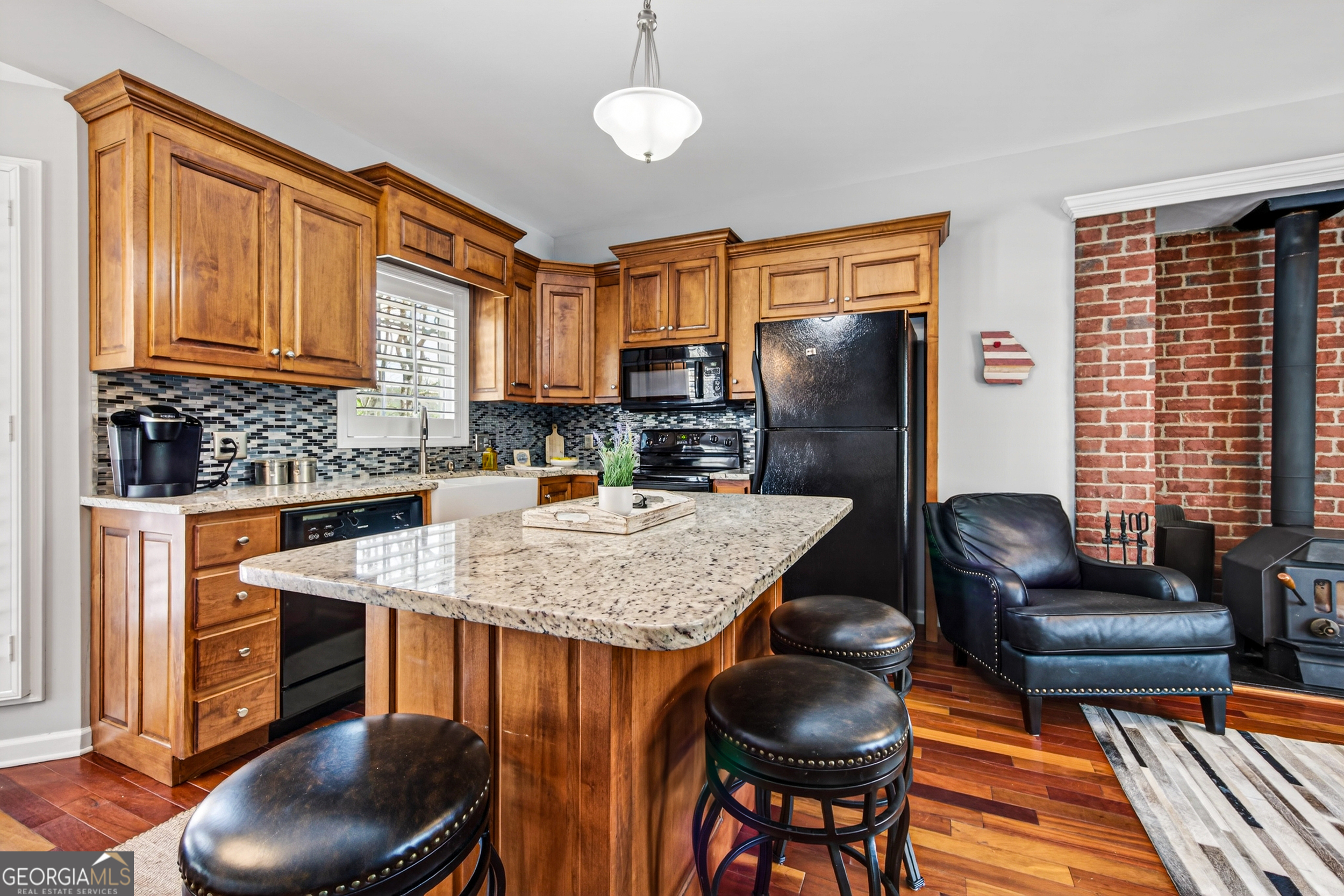 1071 Louden Ridge Road Alto, GA 30510 - Photo 14 of 81 a kitchen with stainless steel appliances granite countertop a table chairs and a refrigerator