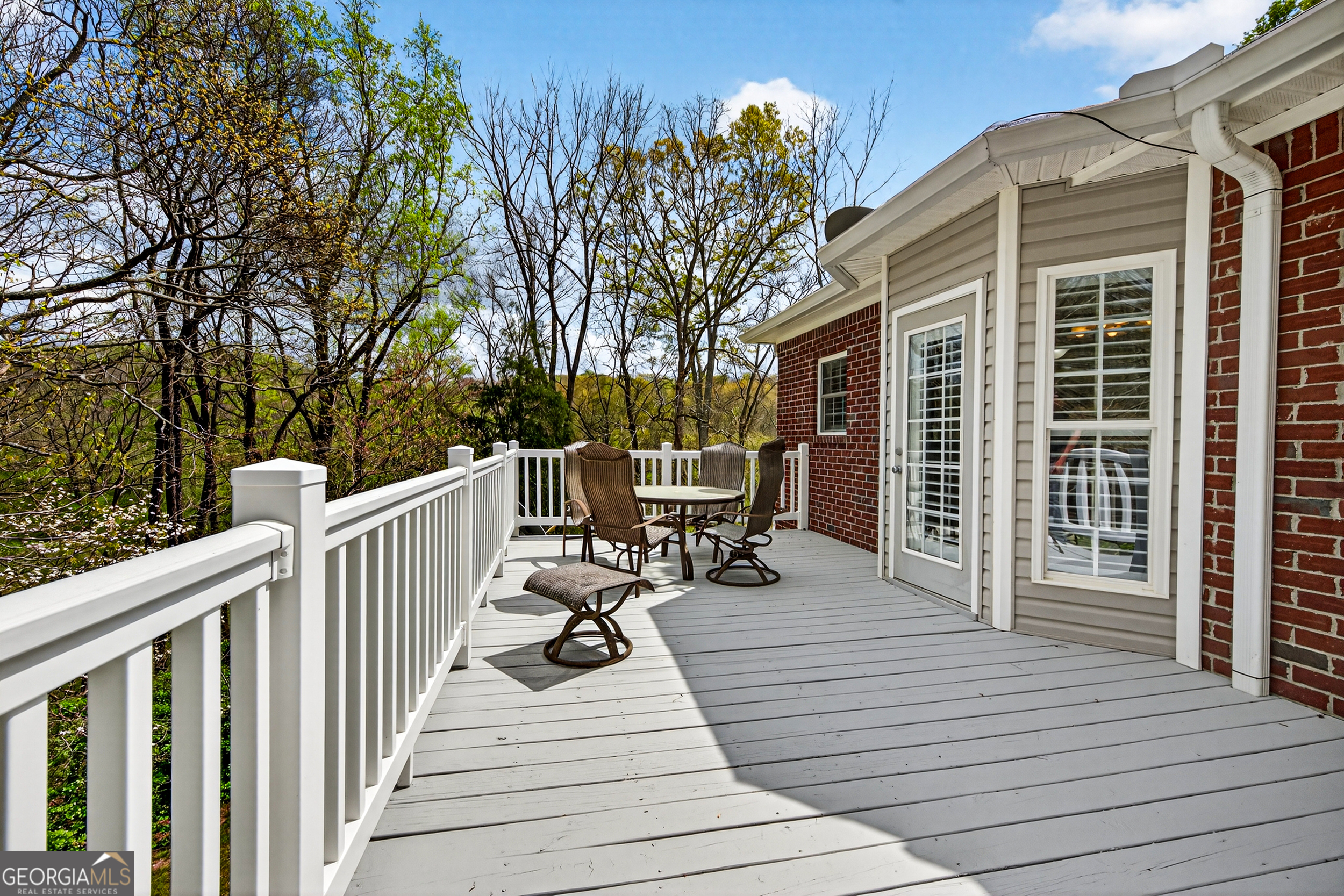 1071 Louden Ridge Road Alto, GA 30510 - Photo 37 of 81 a view of a deck with chairs and wooden fence next to a yard