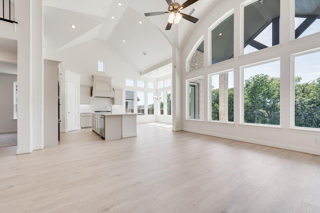 a view of a kitchen with kitchen island a sink stainless steel appliances and cabinets