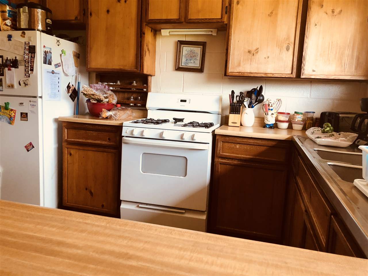 1752 West Kuiaha Road Haiku, HI 96708 - Photo 16 of 24 a kitchen with stainless steel appliances granite countertop a stove a sink and a refrigerator