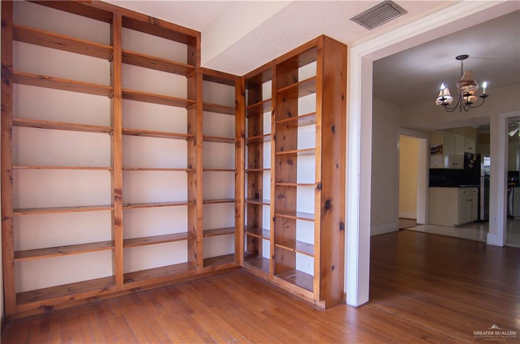 26717 Baker Potts Road Harlingen, TX 78552 - Photo 11 of 18 a view of wooden floor and windows in a room