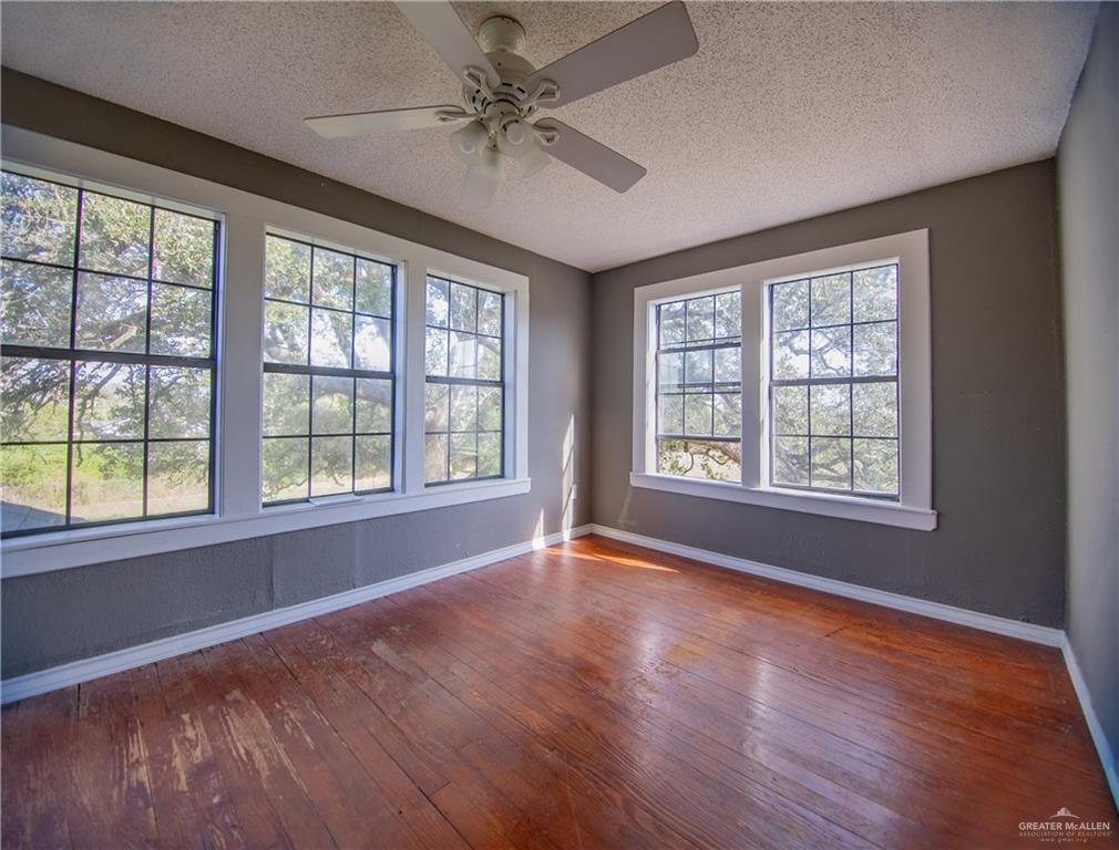 26717 Baker Potts Road Harlingen, TX 78552 - Photo 15 of 18 a view of an empty room with wooden floor and a window