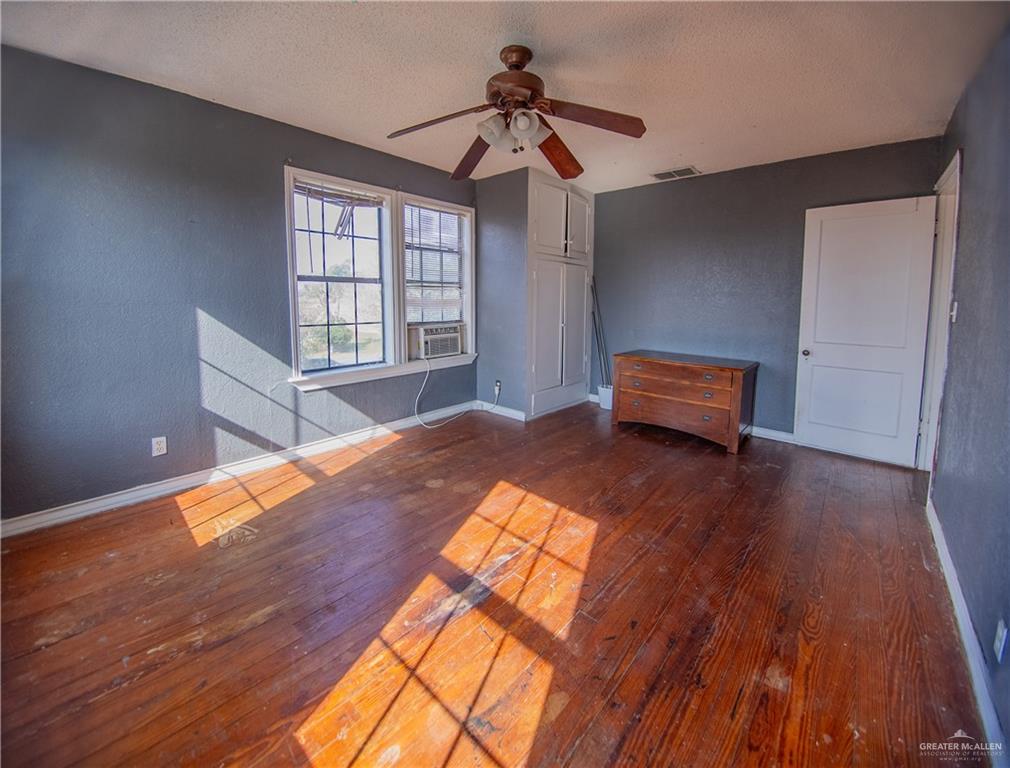 26717 Baker Potts Road Harlingen, TX 78552 - Photo 18 of 18 a bedroom with a bed and wooden floor