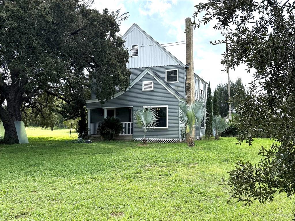 26717 Baker Potts Road Harlingen, TX 78552 - Photo 2 of 18 a front view of a house with a garden