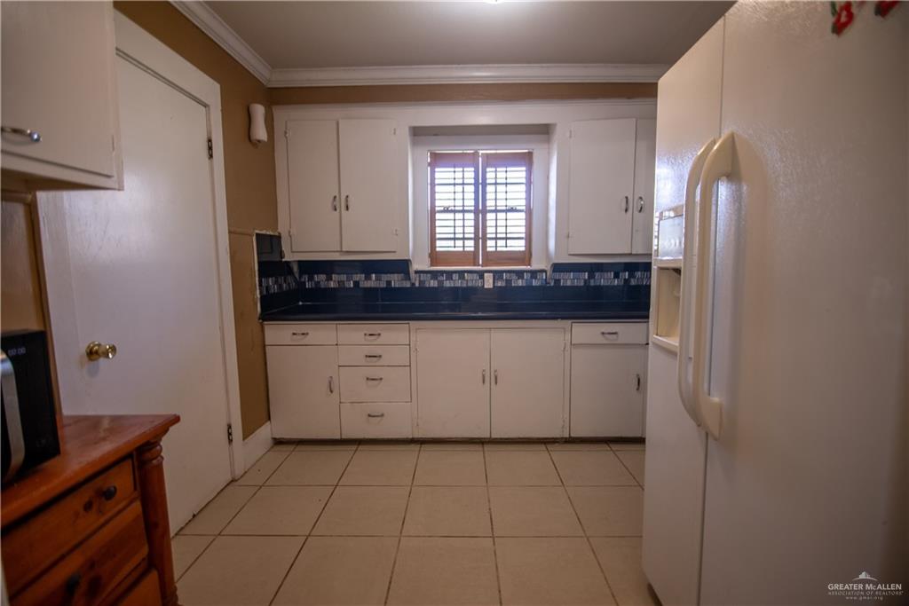 26717 Baker Potts Road Harlingen, TX 78552 - Photo 6 of 18 a utility room with granite countertop white cabinets and a sink