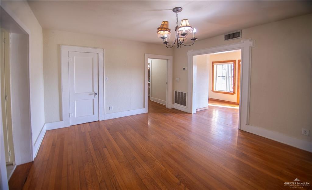 26717 Baker Potts Road Harlingen, TX 78552 - Photo 7 of 18 a view of a livingroom with a chandelier wooden floor and chandelier