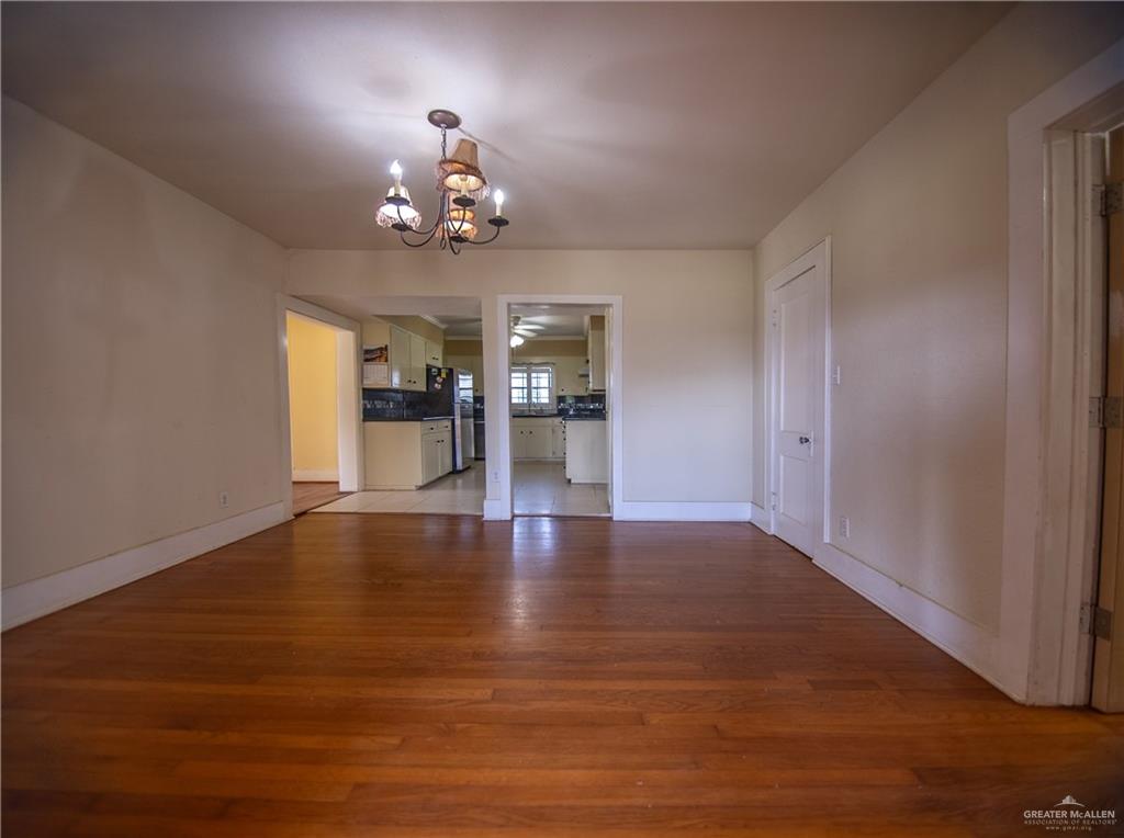 26717 Baker Potts Road Harlingen, TX 78552 - Photo 10 of 18 a view of an empty room with a window and wooden floor