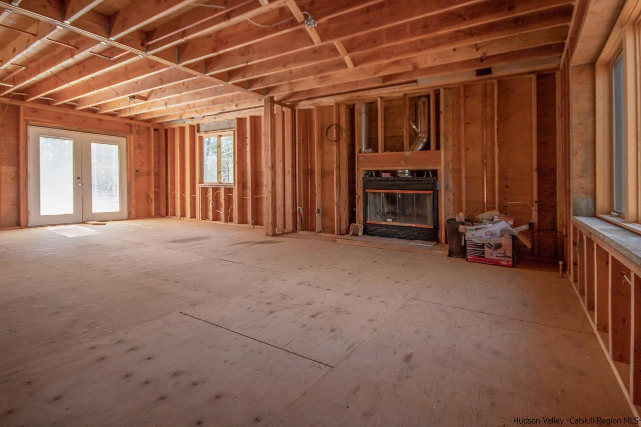 59 Markle Road Kerhonkson, NY 12446 - Photo 4 of 24 a view of an empty room with furniture and a window