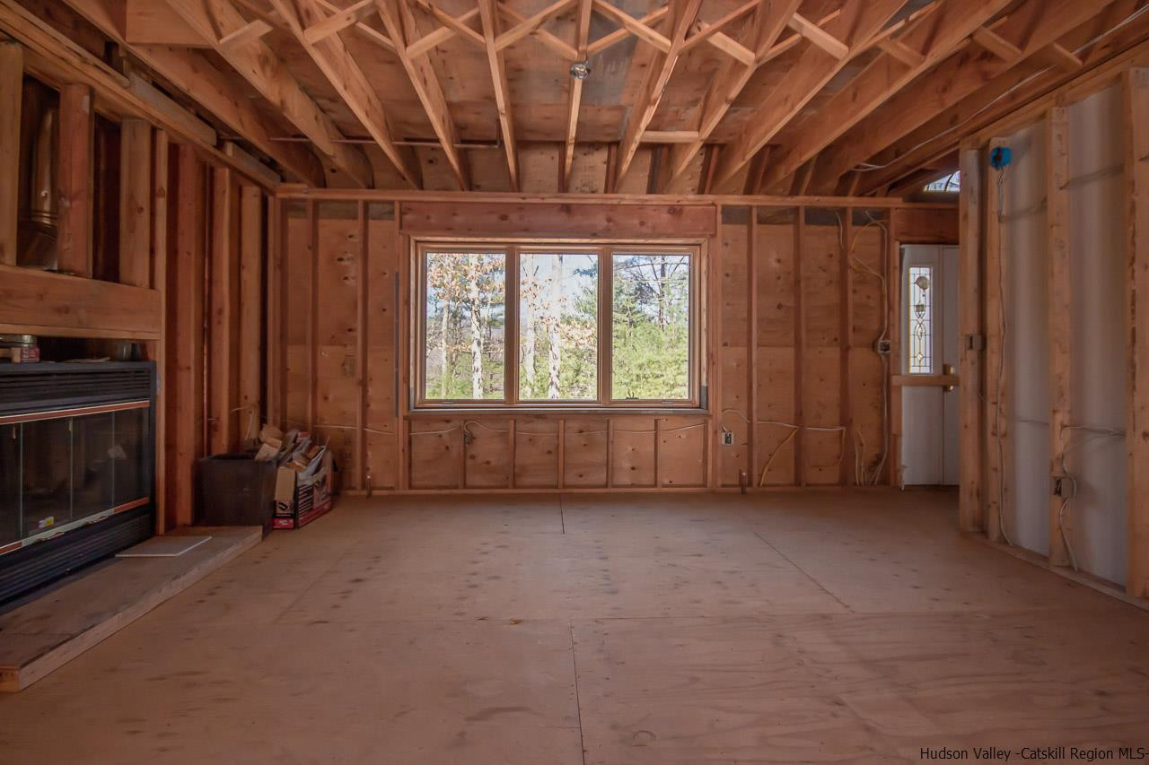 59 Markle Road Kerhonkson, NY 12446 - Photo 6 of 24 a view of an empty room with a fireplace