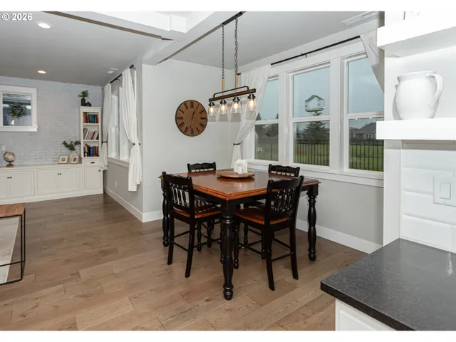 a dining room with a wooden table and chairs