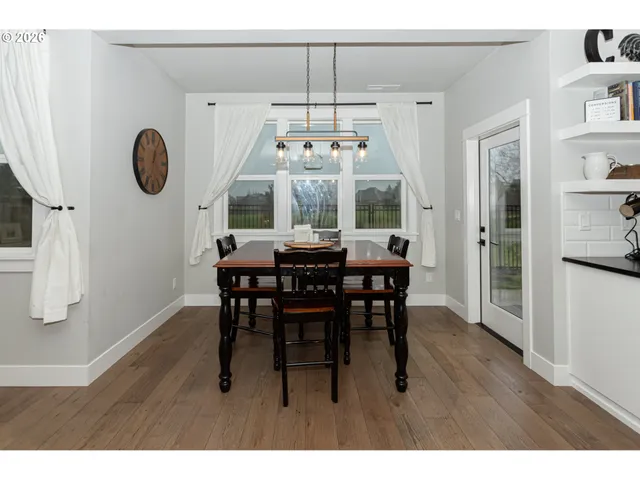 a view of a dining room with furniture wooden floor and chandelier