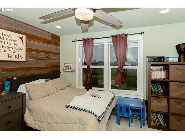 a bedroom with a bed dresser and a book shelf