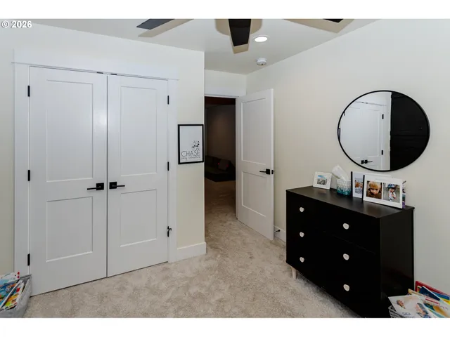 a living room with a dresser and a mirror