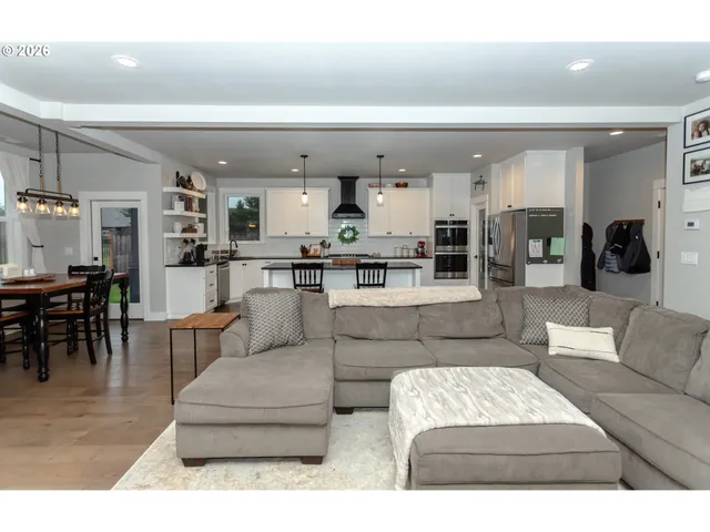 a living room with furniture and kitchen view