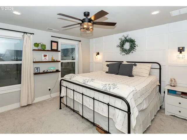 a bedroom with a large bed and a chandelier