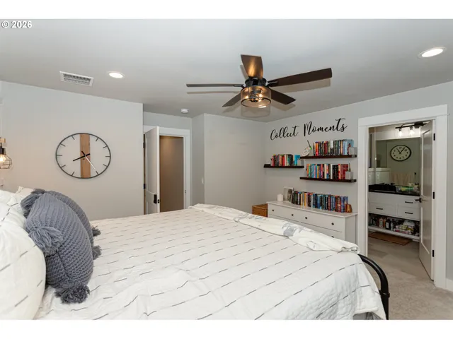 a bedroom with a large bed and a chandelier