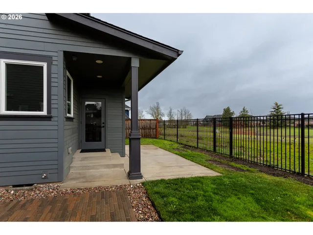 a view of a backyard with wooden fence