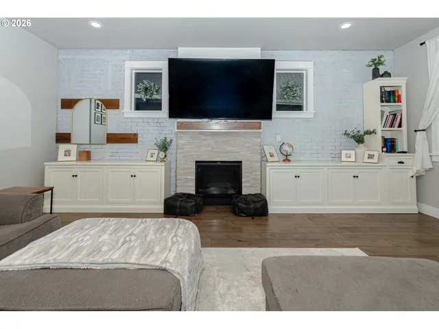 a living room with fireplace furniture and a flat screen tv