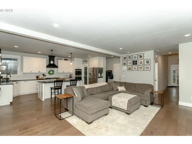 a living room with furniture and kitchen view