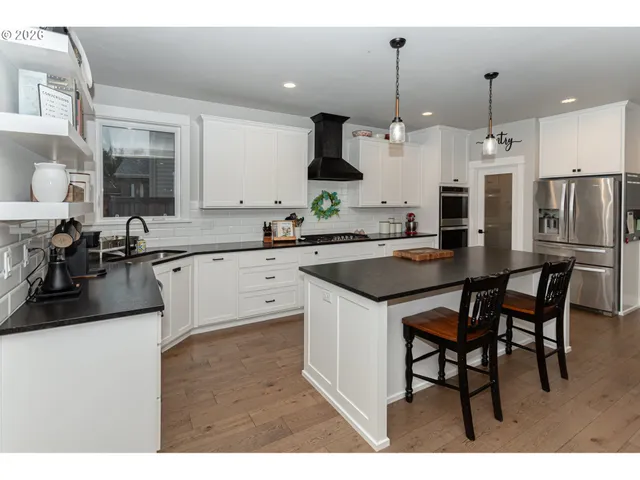 a kitchen with a sink and chairs