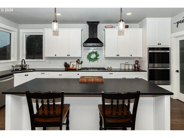 a kitchen with a stove a sink and a refrigerator