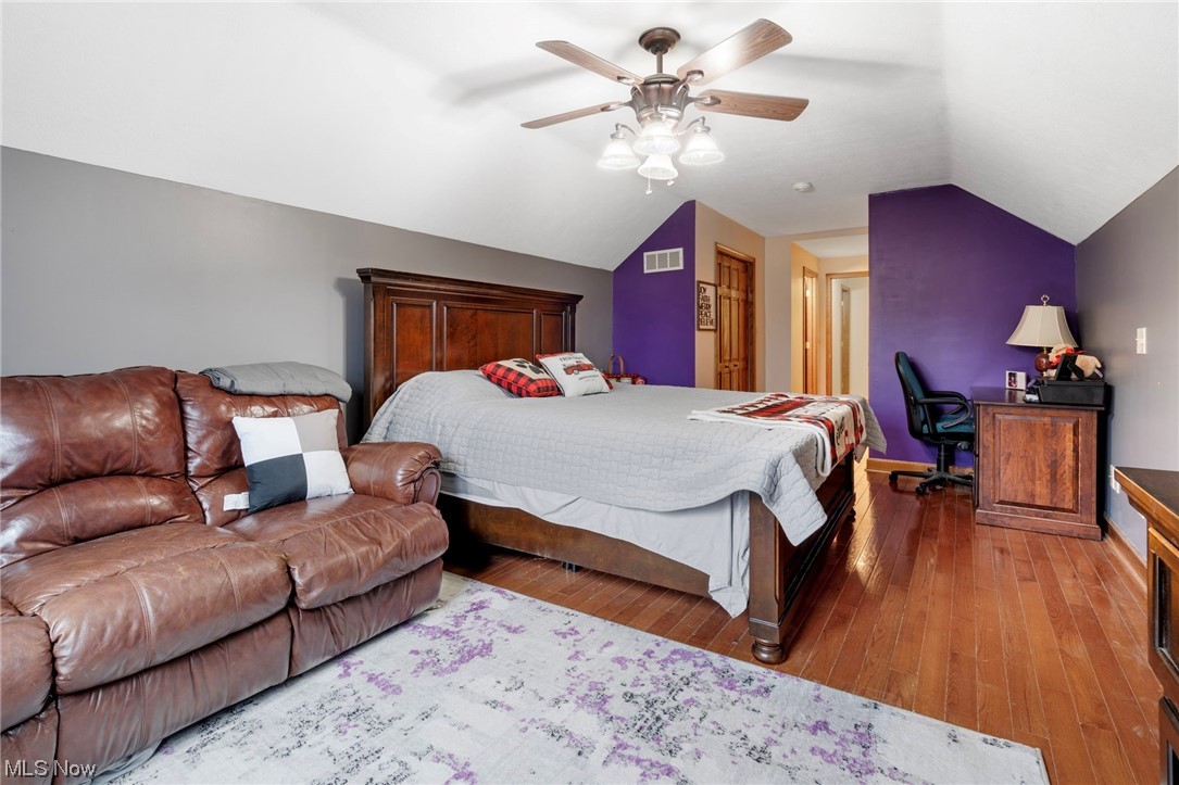 4915 Monticello Street Northwest Canton, OH 44708 - Photo 24 of 31 Master Bedroom featuring lofted ceiling, ceiling fan, and hardwood flooring