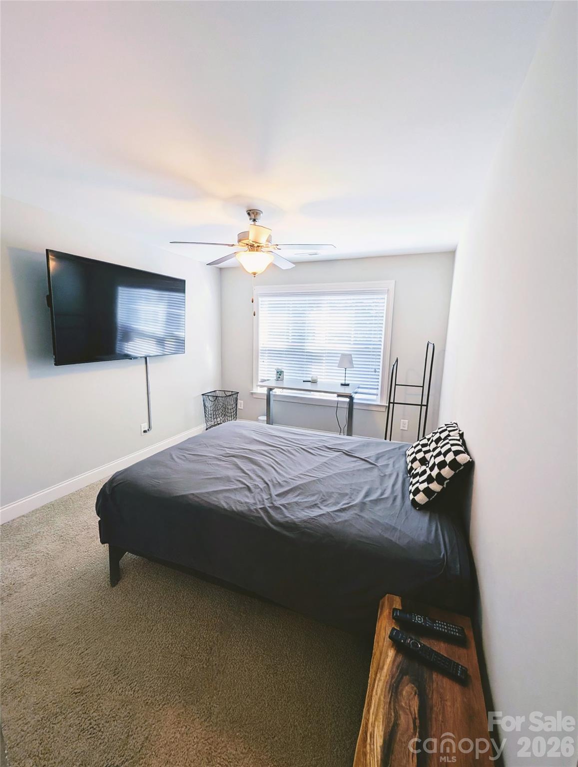 19934 Walter Henderson Road Cornelius, NC 28031 - Photo 25 of 35 a bedroom with a bed and a chandelier