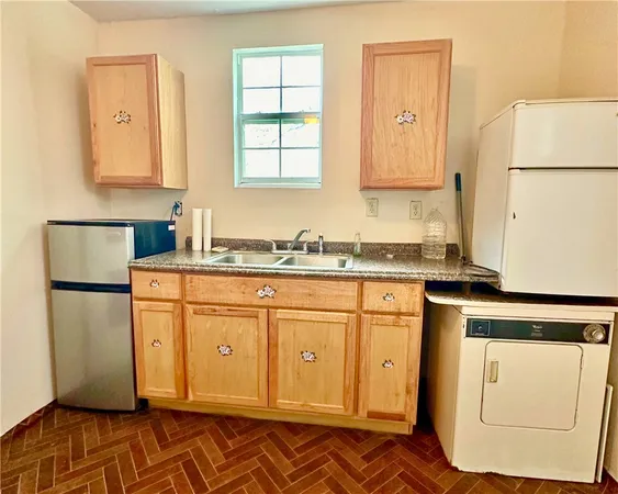 a kitchen with stainless steel appliances granite countertop a refrigerator sink and cabinets