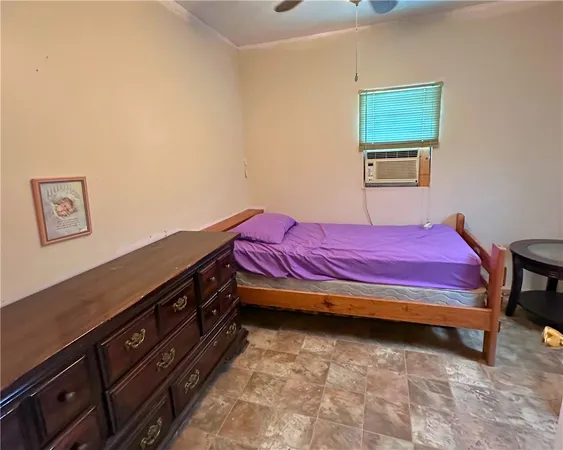 a spacious bedroom with a bed and a dresser in it