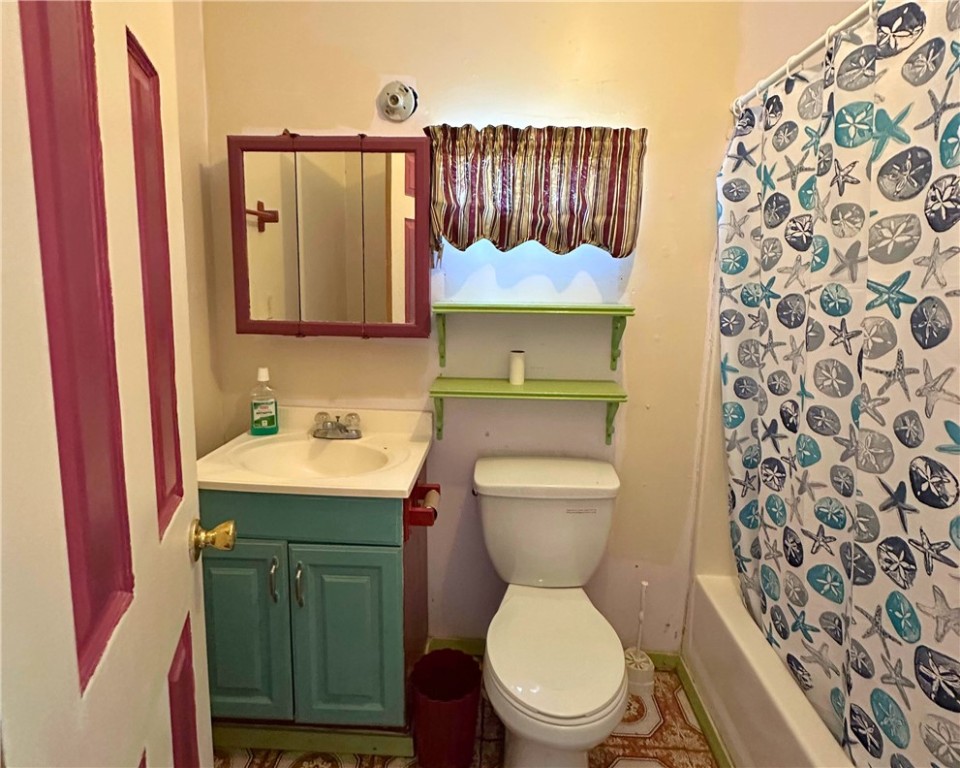 600 South Rachal Sinton, TX 78387 - Photo 14 of 17 a bathroom with a toilet sink vanity and mirror