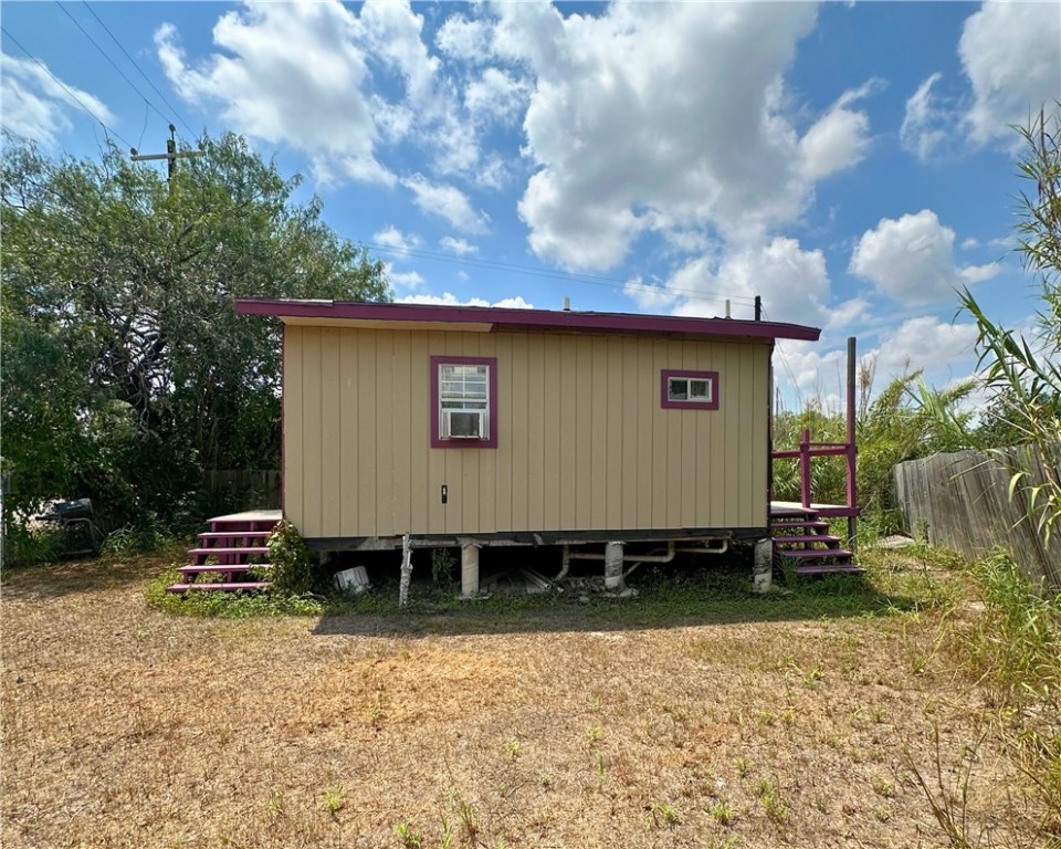 600 South Rachal Sinton, TX 78387 - Photo 17 of 17 a backyard of a house with a yard and trees