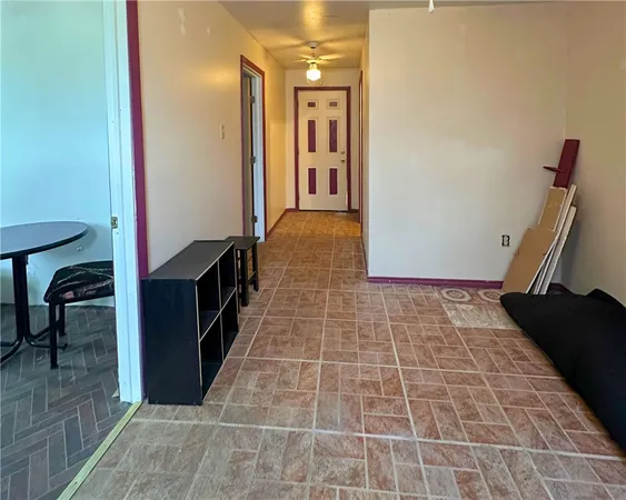a view of a hallway with wooden floor and furniture