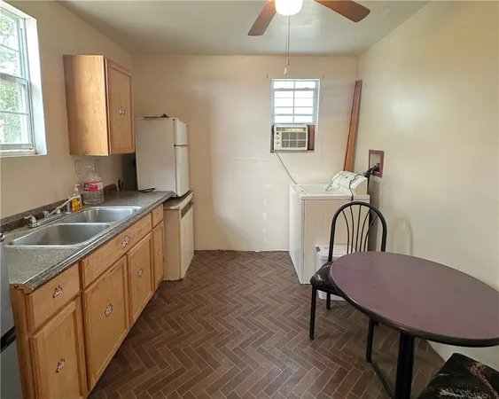a kitchen with a dining table chairs and a sink