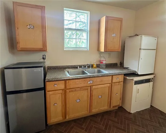 a kitchen with stainless steel appliances granite countertop a refrigerator sink and cabinets
