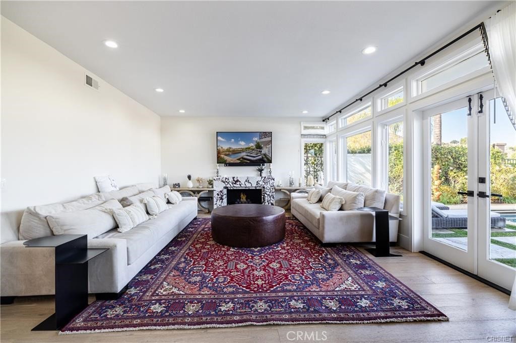 3626 Paseo Primario Calabasas, CA 91302 - Photo 11 of 41 a living room with furniture hard wood floor and a rug