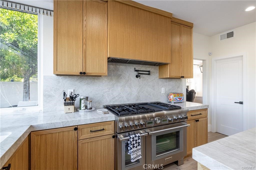 3626 Paseo Primario Calabasas, CA 91302 - Photo 14 of 41 a kitchen with a stove and a sink