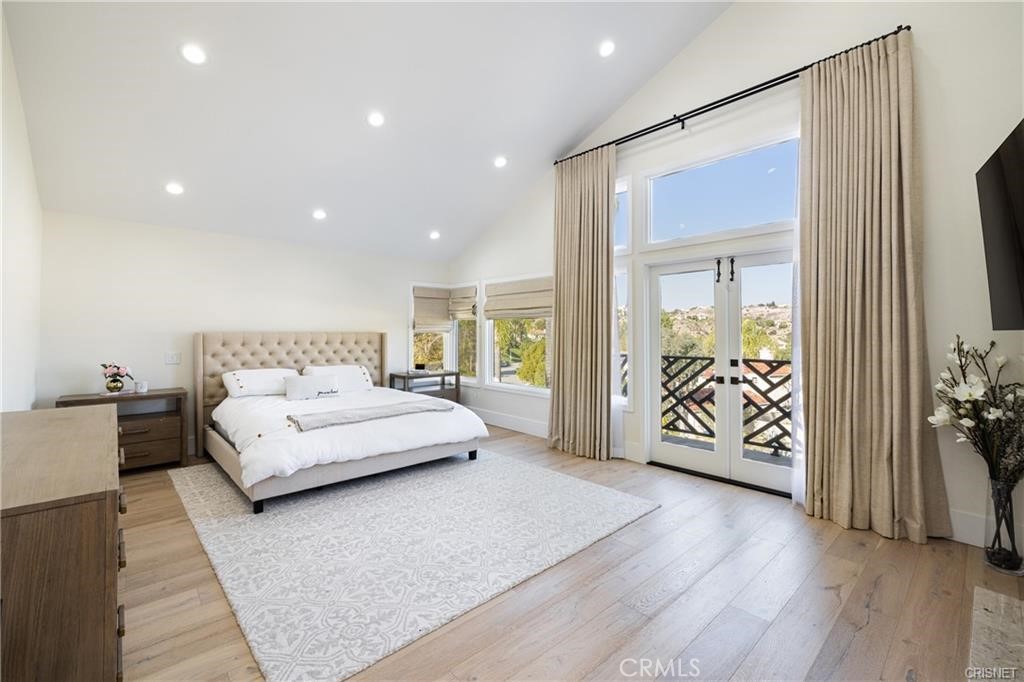 3626 Paseo Primario Calabasas, CA 91302 - Photo 18 of 41 a spacious bedroom with a balcony a bed and a couch